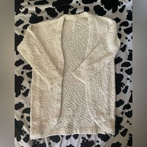 White cardigan with gold accents